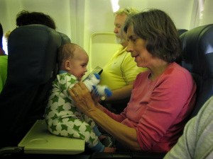 Grandmother-With-Infant-On-Board-Aircraft